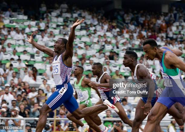 Linford Christie of Great Britain crosses the finish line to win the Men's 100 metres race from silver medal winner Frankie Fredericks of Namibia and...