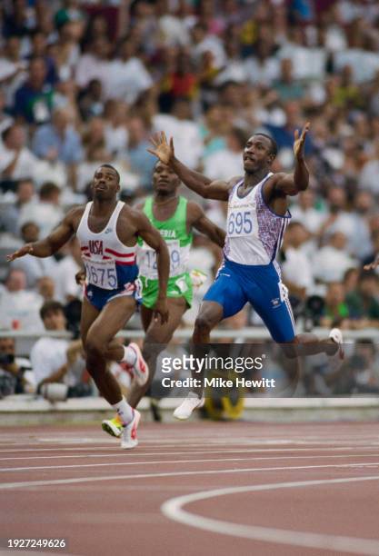 Linford Christie of Great Britain raises his arms in celebration as he crosses the finish line to win the Men's 100 metres race on 1st August 1992...