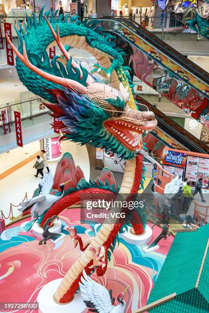 Meter-long dragon-shaped decorative installation is displayed at Shenyang Joy City ahead of the Chinese New Year, the Year of the Dragon, on January...