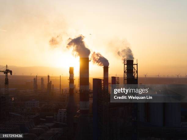 the chimney of the chemical plant is smoking - industrial building stock pictures, royalty-free photos & images