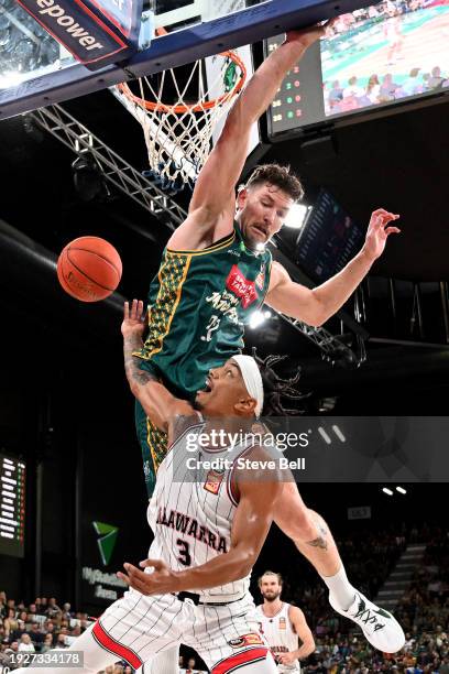 Will Magnay of the Jackjumpers blocks the shot of Justin Robinson of the Hawks during the round 15 NBL match between Tasmania Jackjumpers and...