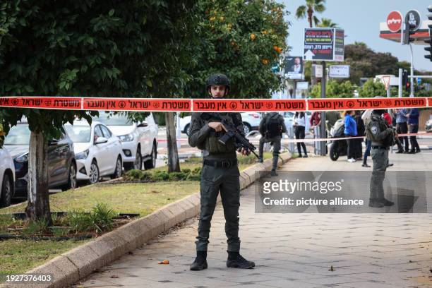 January 2024, Israel, Ra'anana: An Israeli security officer stands at the scene of a ramming attack in Ra'anana. An Israeli woman was killed, and 18...