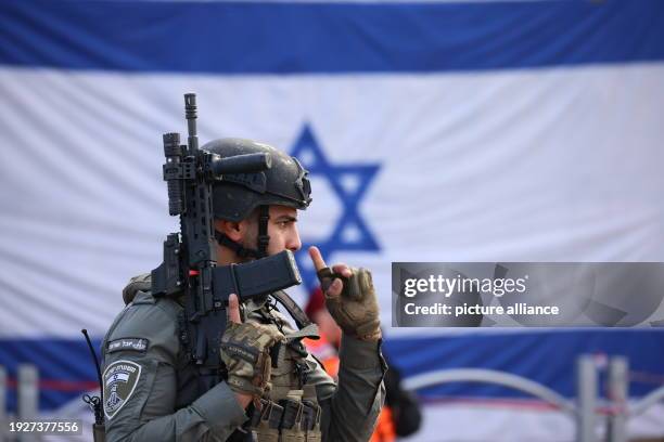 January 2024, Israel, Ra'anana: An Israeli security officer stands at the scene of a ramming attack in Ra'anana. An Israeli woman was killed, and 18...