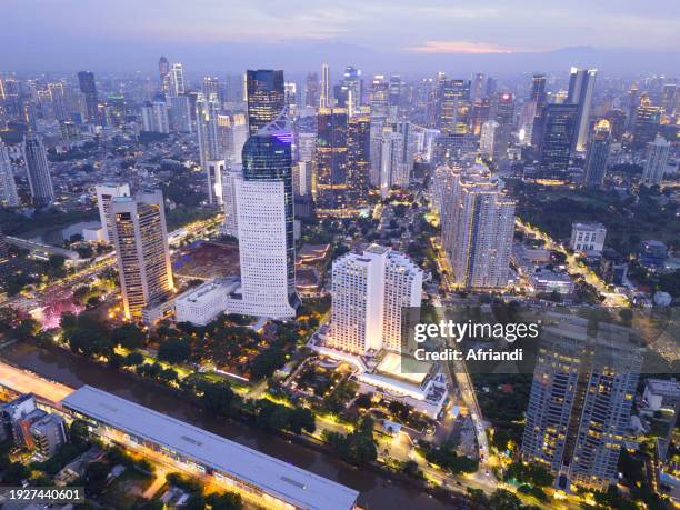 aerial view of jakarta city skyline at dusk - indonesia city stock pictures, royalty-free photos & images