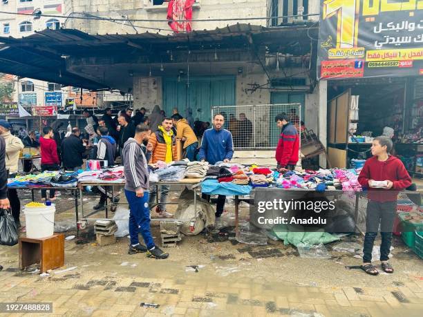 Palestinians shop for food and clothes at the local bazaar as daily life continues in the shadow of war in Jabalia, Gaza on January 15, 2024.