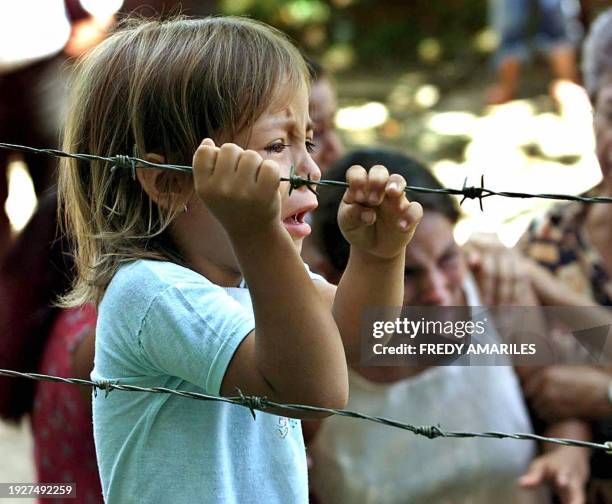 Child cries the death of her father, one of nine men killed by the FARC last weekend, 12 July, 2004 in the village of San Carlos, Antioquia, 450 km...