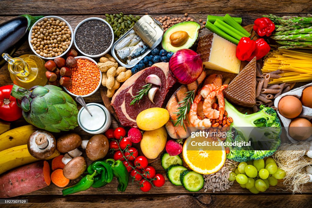 Composition of healthy food aranged in a row on wooden table