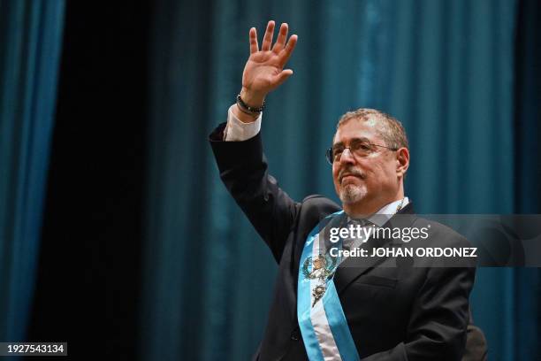 Guatemala's new President Bernardo Arevalo waves after swearing in during his inauguration ceremony at the Miguel Angel Asturias Cultural Centre in...