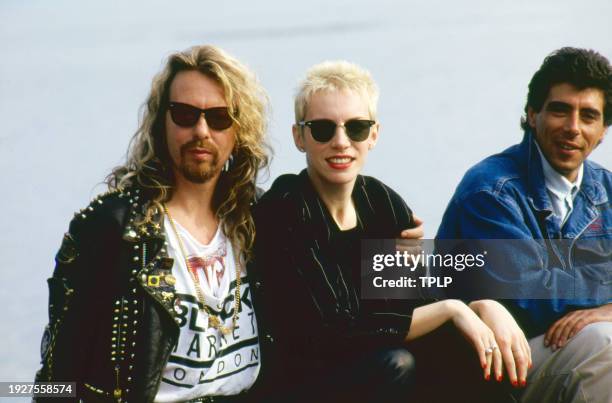 Portrait of, from left, New Wave and Pop musicians Dave Stewart and Annie Lennox, both of the duo Eurythmics, and DJ Gary Davies during an interview...