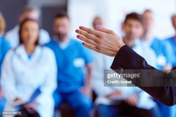 doctor and nurses attending healthcare seminar - bokeh stock pictures, royalty-free photos & images