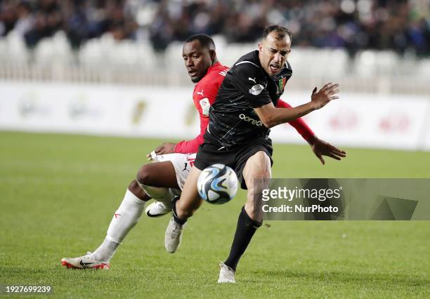 Wamba Djouffo Leonel of CR Belouizdad is fighting for the ball with Benlamri Djamel of MC Alger during the football match between CR Belouizdad and...