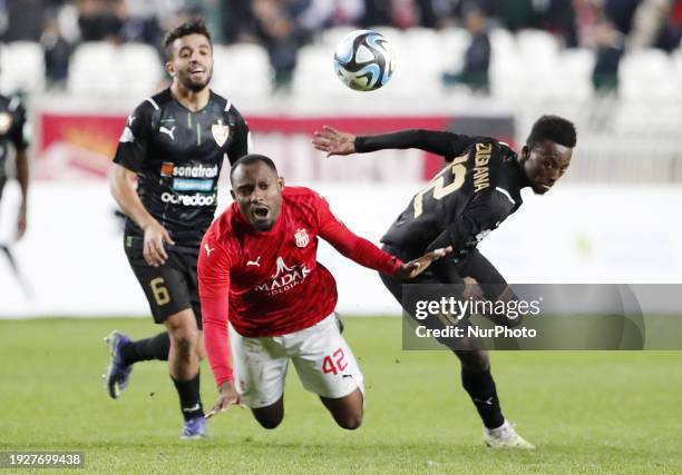 Wamba Djouffo Leonel of CR Belouizdad is fighting for the ball with Zougrana Mohamed of MC Alger during the football match between CR Belouizdad and...