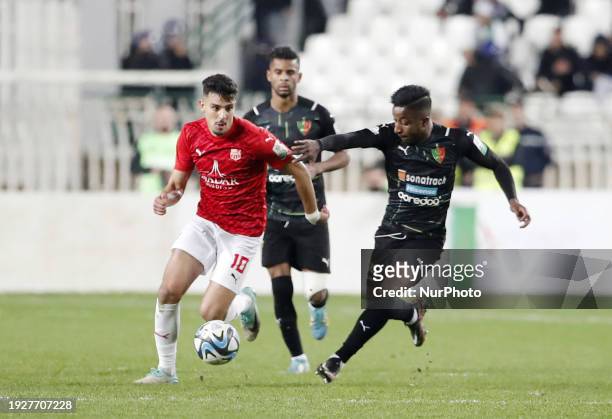 Boussouf Talal of CR Belouizdad is fighting for the ball with Touki Badr Eddine of MC Alger during the football match between CR Belouizdad and MC...