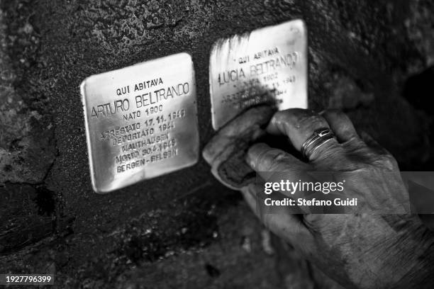 The artist Gunter Demnig cleans the "Memory Blocks" after they have been installed in the ground on January 12, 2024 in Turin, Italy. The German...