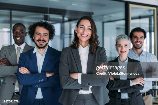 confident businesswoman and her team. - staff meeting stock pictures, royalty-free photos & images