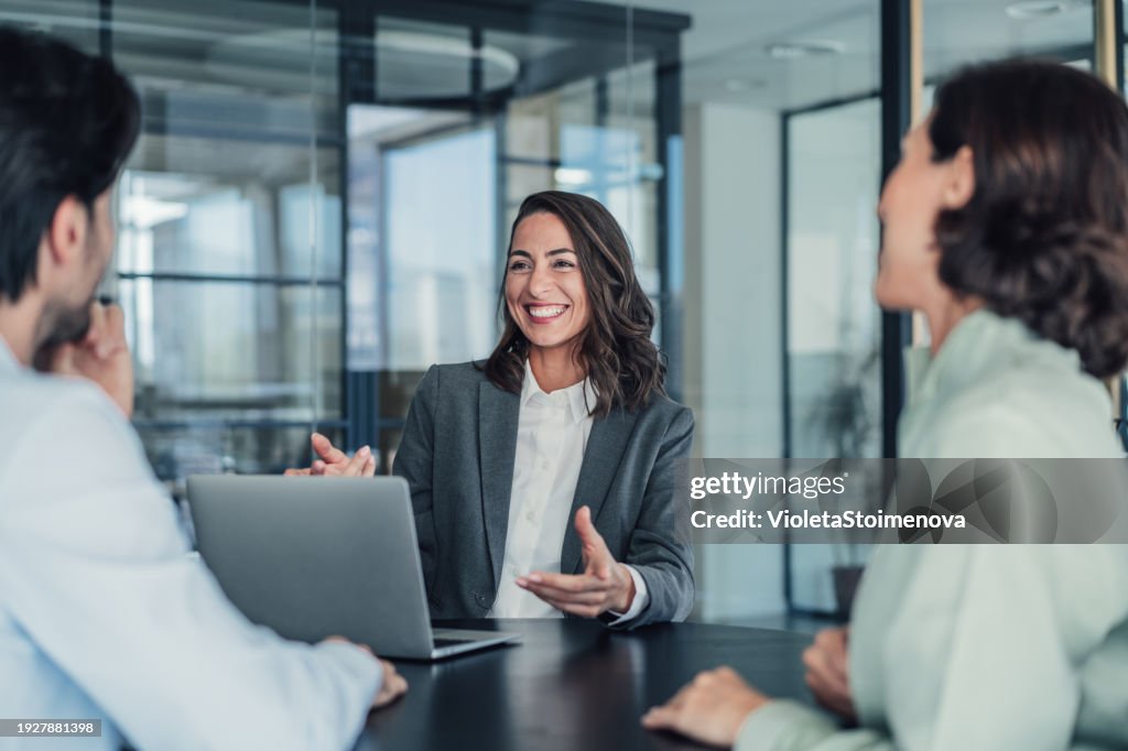 Group of business persons talking in the office.