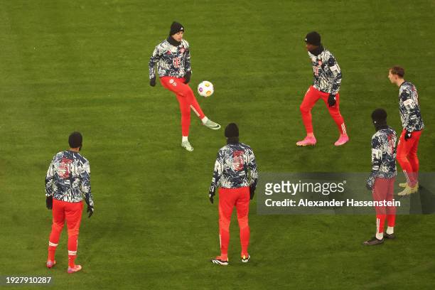 The players of Bayern Munich warm up whilst wearing shirts which display the number '5' after the passing of former German football player and...