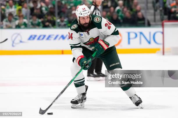 Zach Bogosian of the Minnesota Wild skates with the puck during the third period against the Dallas Stars at American Airlines Center on January 10,...