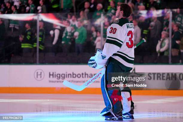 Jesper Wallstedt of the Minnesota Wild stands on the ice during the playing of the U.S. National anthem before his NHL debut against the Dallas Stars...
