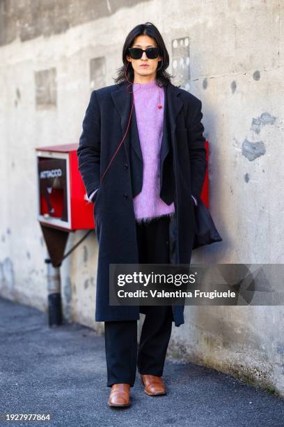 Guest is seen wearing black sunglasses, a lilac sweaters, a blue jacket, a blue long coat, blue trousers and brown leather boots outside Gucci show...