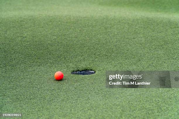 coloured golf ball on putting green - crazy golf course stock pictures, royalty-free photos & images
