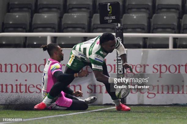 Onisi Ratave of Benetton Rugby breaks through the tackle of Elliott Obatoyinbo of Newcastle Falcons to score their team's second try during the EPCR...