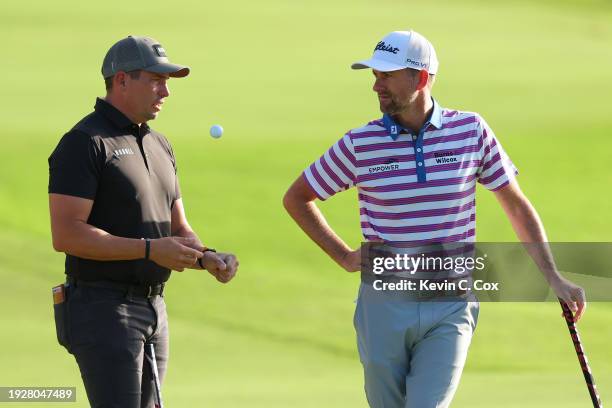 Scott Stallings of the United States speaks with Webb Simpson of the United States on the third green during the second round of the Sony Open in...