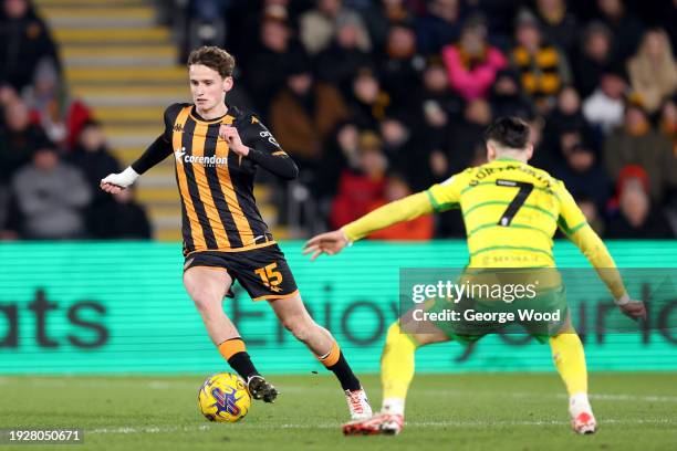 Tyler Morton of Hull City runs with the ball under pressure from Borja Sainz of Norwich City during the Sky Bet Championship match between Hull City...