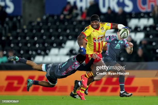 Apisai Naqalevu of USA Perpignan is tackled by Keelan Giles of Ospreys during the EPCR Challenge Cup match between Ospreys and USAP at Swansea.com...