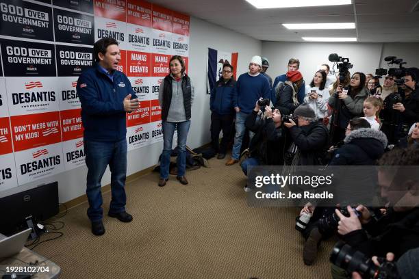 Iowa Gov. Kim Reynolds listens as Republican presidential candidate Florida Governor Ron DeSantis speaks during a visit to a campaign office on...