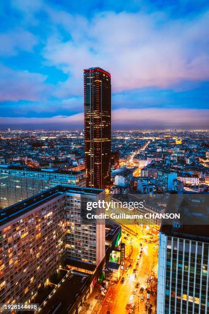 montparnasse tower from a rooftop at blue hour, paris, france. - tour montparnasse stock pictures, royalty-free photos & images