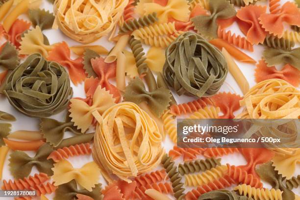 high angle view of various pasta on table - paccheri bildbanksfoton och bilder