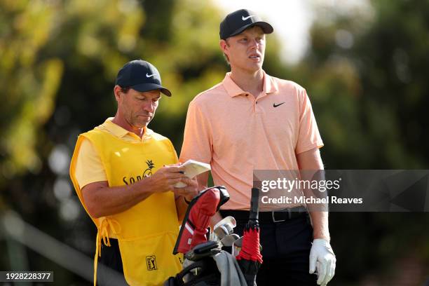 Cameron Davis of Australia looks on with caddie, Andrew Tschudin, on the 16th tee during the second round of the Sony Open in Hawaii at Waialae...
