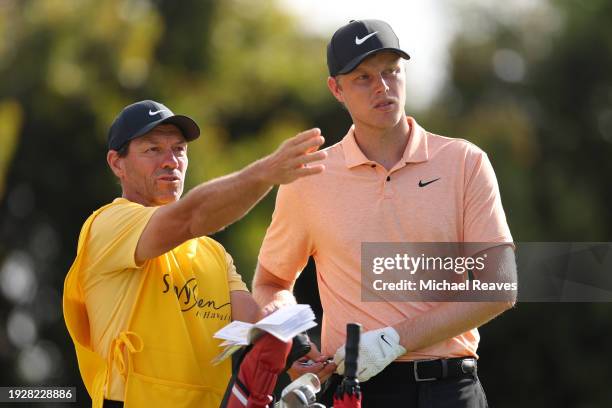 Cameron Davis of Australia prepares for a shot with caddie, Andrew Tschudin, on the 16th tee during the second round of the Sony Open in Hawaii at...