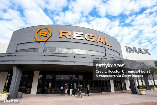 Customers walk outside the front doors at Regal MarqE Cinema on Tuesday, Dec. 26, 2023 in Houston.