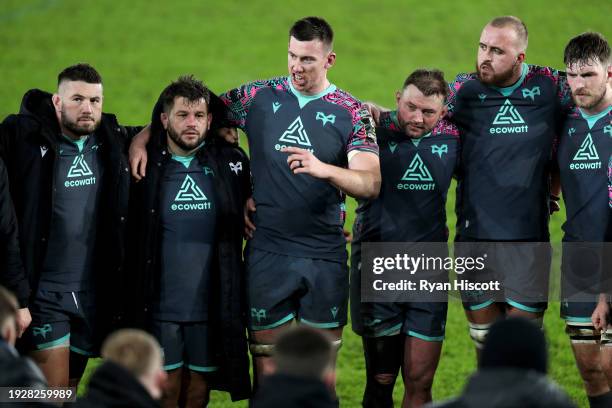 Adam Beard of Ospreys takes a team talk as the players of Ospreys form a huddle at full-time following victory in the EPCR Challenge Cup match...