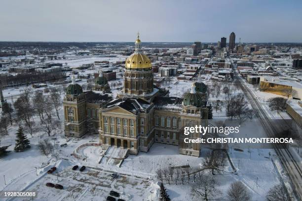 Snow and ice surround the Iowa State Capitol Building in Des Moines, Iowa, on January 15, 2024. Voters will brave subzero temperatures to caucus for...