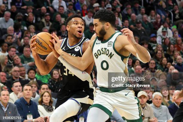 Giannis Antetokounmpo of the Milwaukee Bucks is defended by Jayson Tatum of the Boston Celtics during a game at Fiserv Forum on January 11, 2024 in...