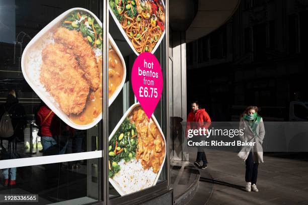 Londoners pass a corner takeaway business selling Bentos lunches in the City of London, the capital's financial district, on 15th January 2024, in...