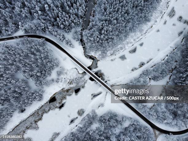 aerial view of road amidst snow covered landscape - azucar stock pictures, royalty-free photos & images