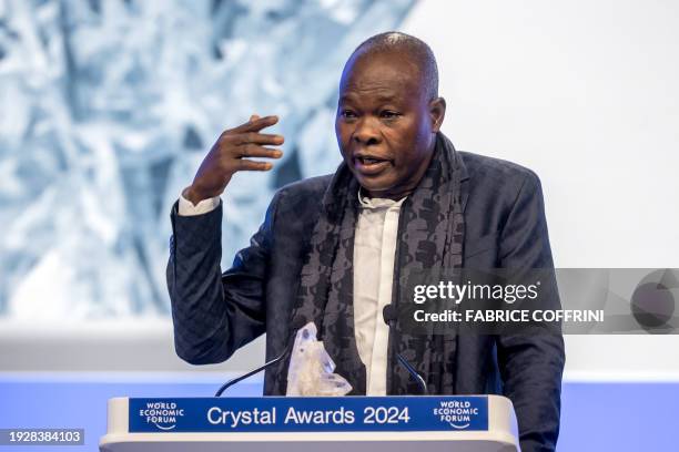 Burkinabe-German architect Diebedo Francis Kere delivers his acceptance speech during the "Crystal Award" ceremony at the opening of the annual...