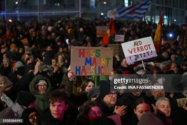 People hold up placards during a demonstration against right extremism and the policy of Germany's far-right the Alternative for Germany party, on...