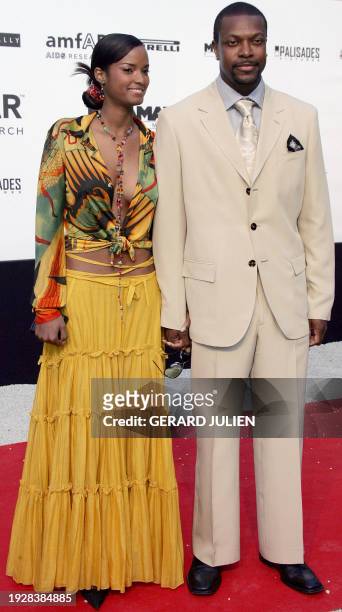 Actor Chris Tucker and his wife pose as they arrive for the American Foundation for AIDS Research "Cinema Against AIDS" benefit in Le Moulin de...