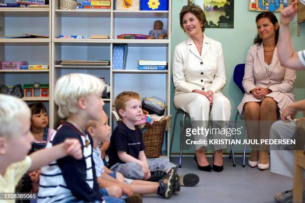 Danish children entertain US First Lady Laura Bush and Anne-Mette Rasmussen the wife of Denmark's Prime Minister Anders Fogh Rasmussen, in the...