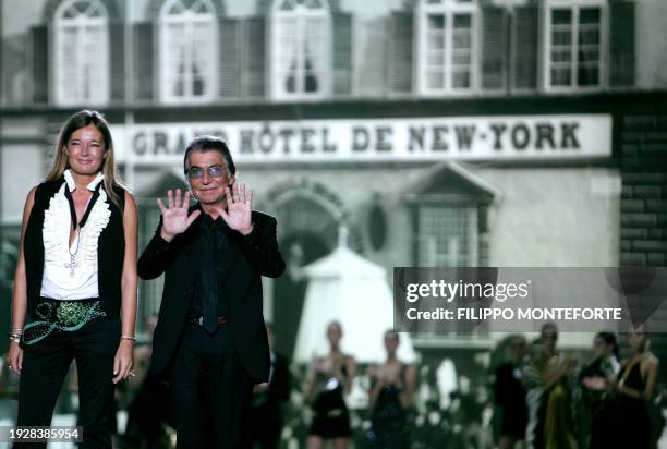 Italian designers Roberto Cavalli and his wife Eva acknowledge applauds from the public at the end of their Spring/Summer 2007 Women's collections...