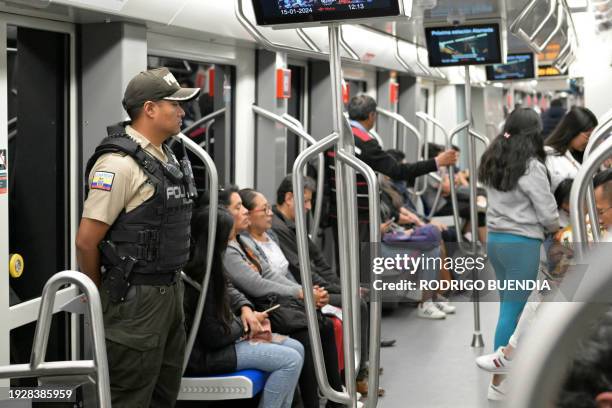 Police officer provides security in a metro in Quito on January 15 days after the government declared a state of emergency and curfew following the...