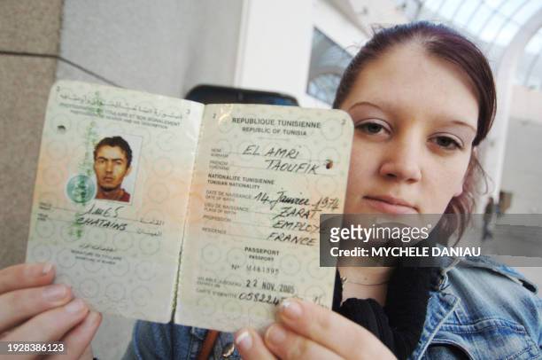 Priscilla al-Amri shows 07 December 2006 in Caen, the passport of her husband Toufik Amri, a 33 year-old worker who went missing last 22 November,...
