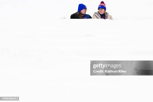 Fans sit in the snow filled seats prior to the NFL wild-card playoff football game between the Pittsburgh Steelers and Buffalo Bills at Highmark...