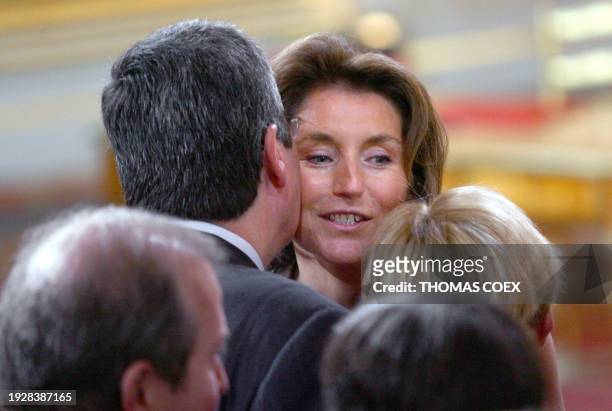 Nicolas Sarkozy's wife Cecilia salutes Levallois' Mayor Patrick Balkany before an official ceremony during which her husband will be invested as...