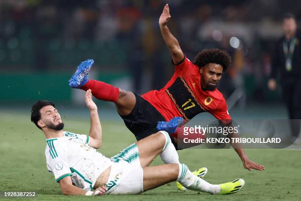 Algeria's defender Rami Bensebaini tackles Angola's midfielder Bruno Paz during the Africa Cup of Nations 2024 group D football match between Algeria...